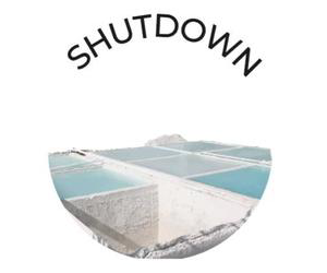 Circular logo with the word "Shutdown" above an image of salt evaporation ponds.